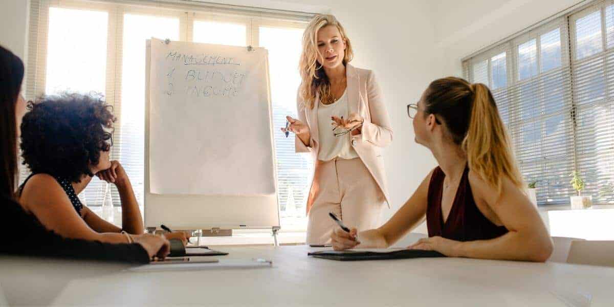 woman standing in leadership in office meeting