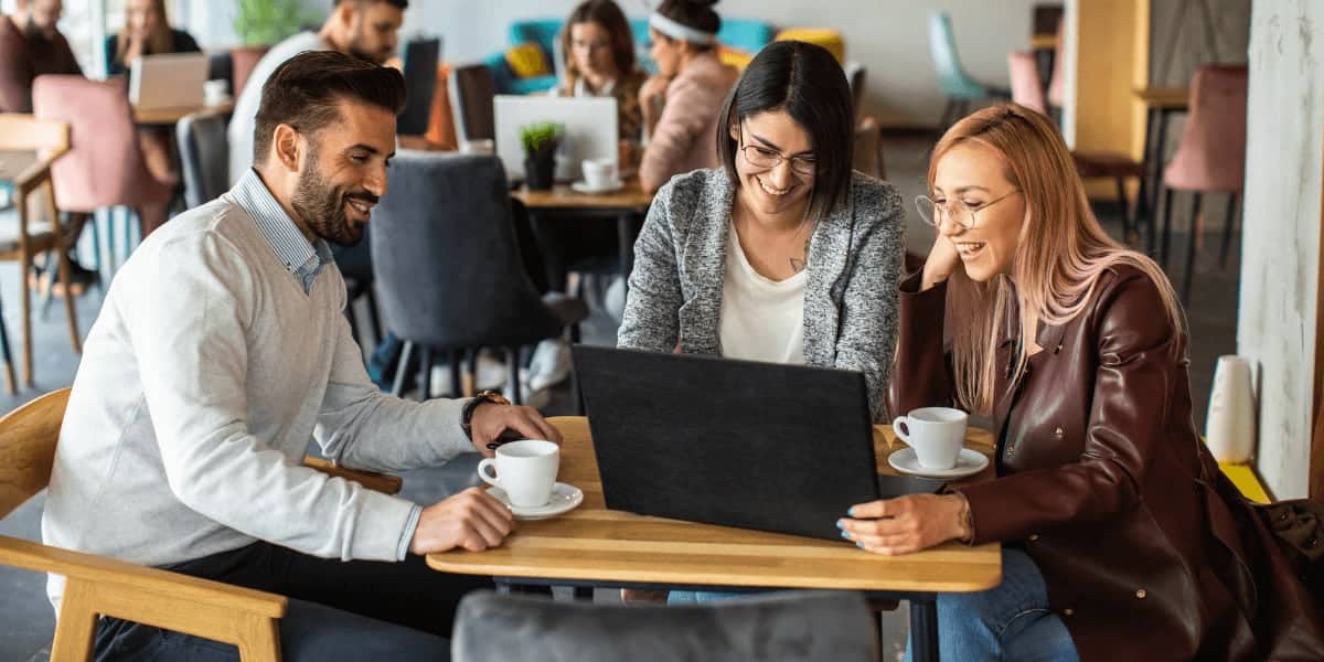 coworkers sitting at desk discussing project