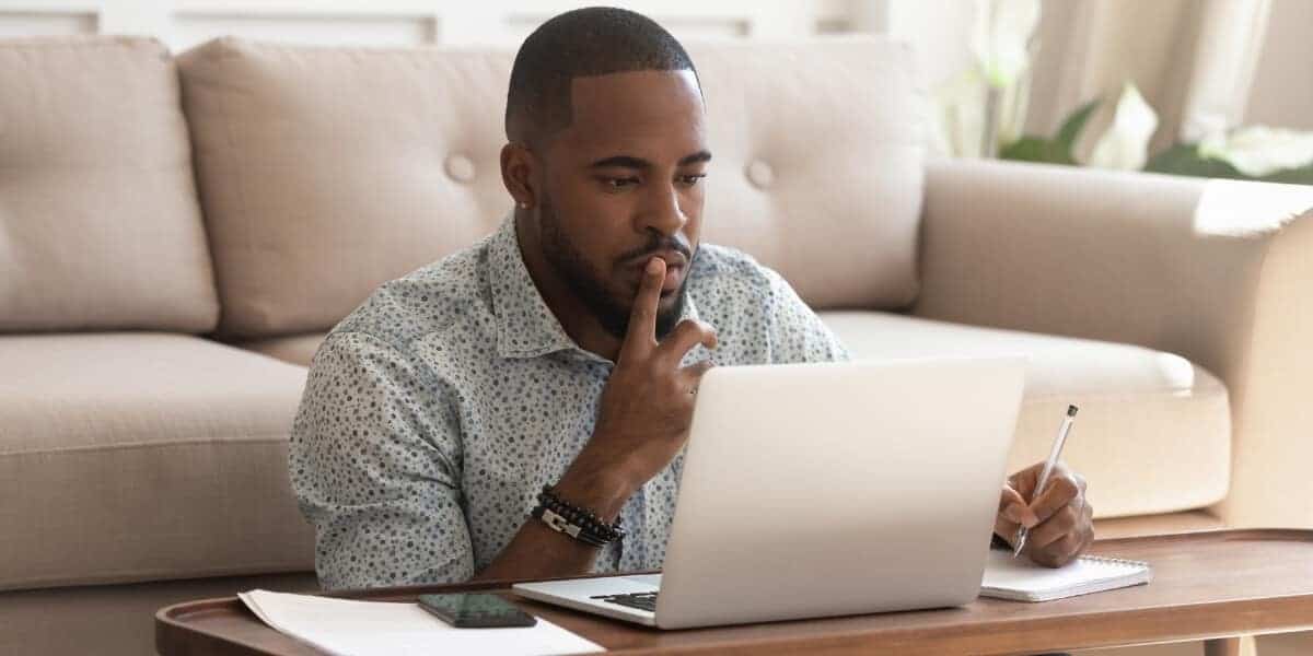 Man sitting at computer researching ICF Certifications