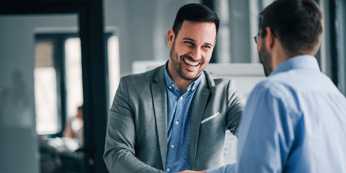 Manager shaking hands with employee