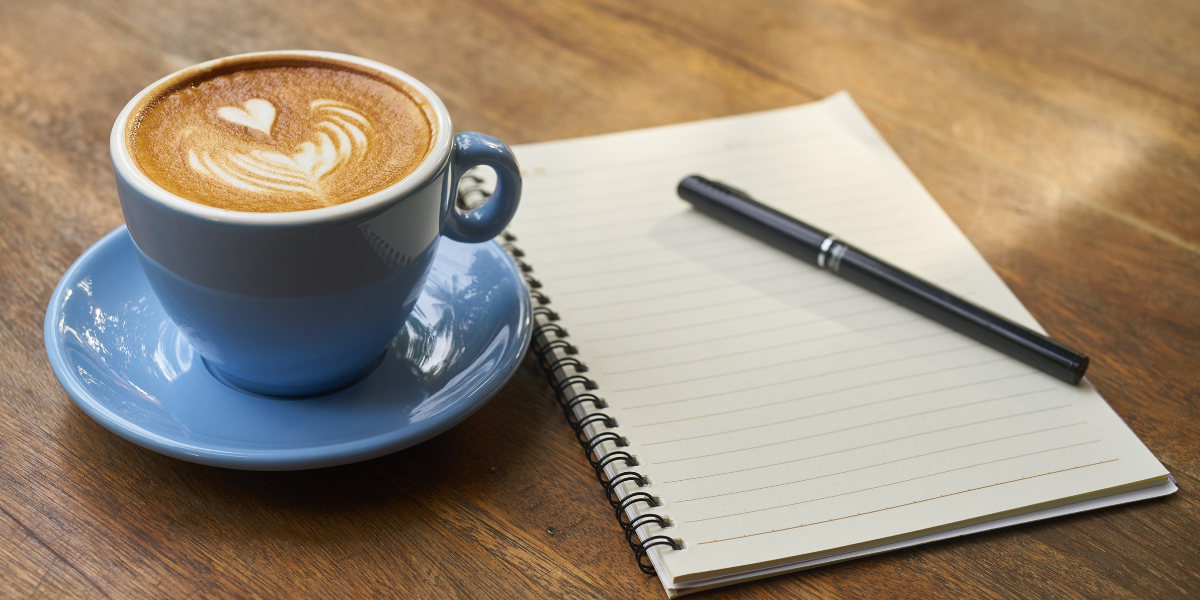 Blue coffee cup with notebook